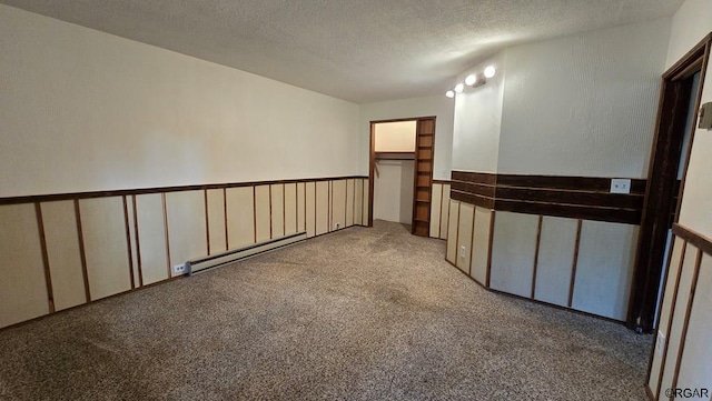 unfurnished room featuring light carpet, a baseboard radiator, and a textured ceiling