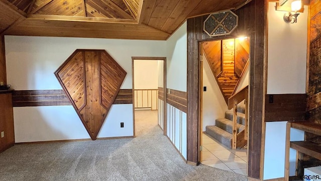 bonus room with light carpet and wooden ceiling