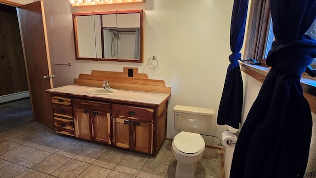 bathroom featuring vanity, a baseboard radiator, tile patterned floors, and toilet