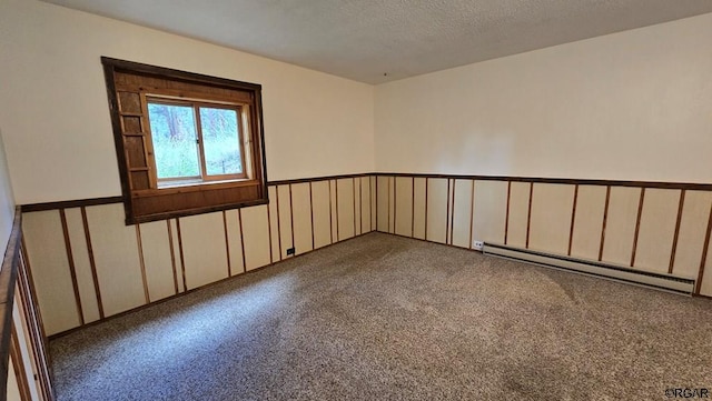 unfurnished room featuring a baseboard radiator and a textured ceiling