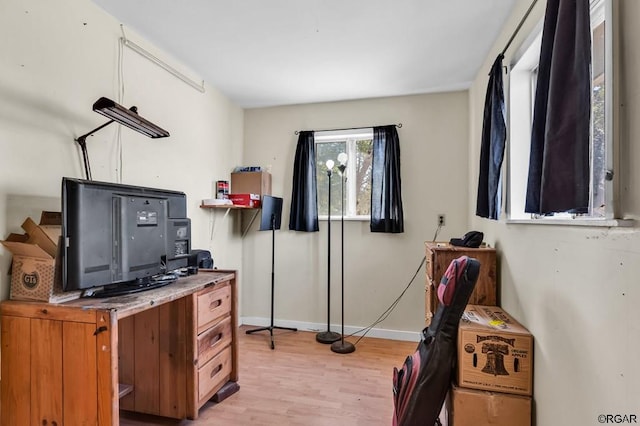 home office with light hardwood / wood-style flooring