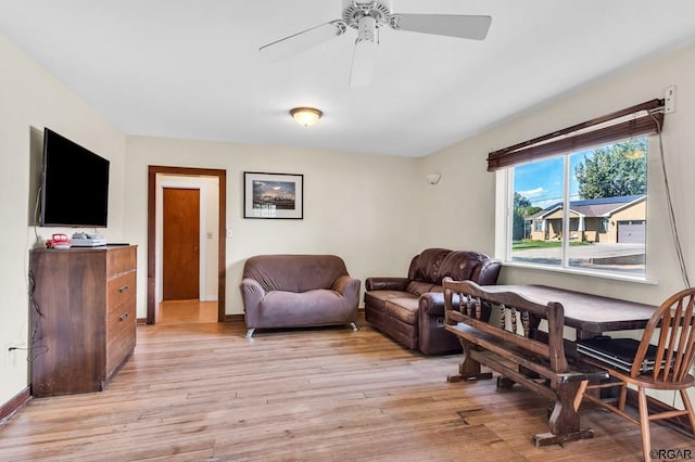 living room featuring ceiling fan and light wood-type flooring