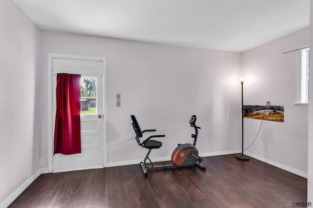 workout room with dark wood-type flooring