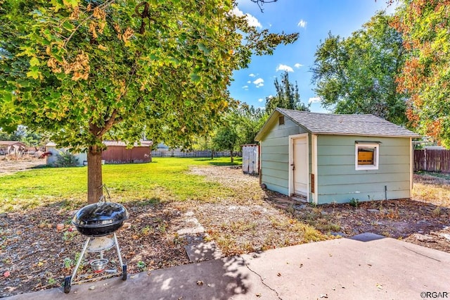 view of yard with a storage shed and a fire pit