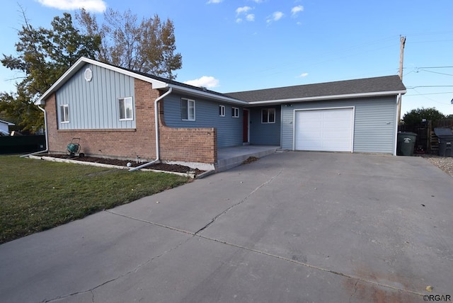 single story home with a garage and a front lawn