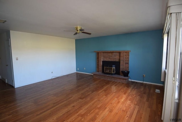 unfurnished living room with ceiling fan and dark hardwood / wood-style flooring