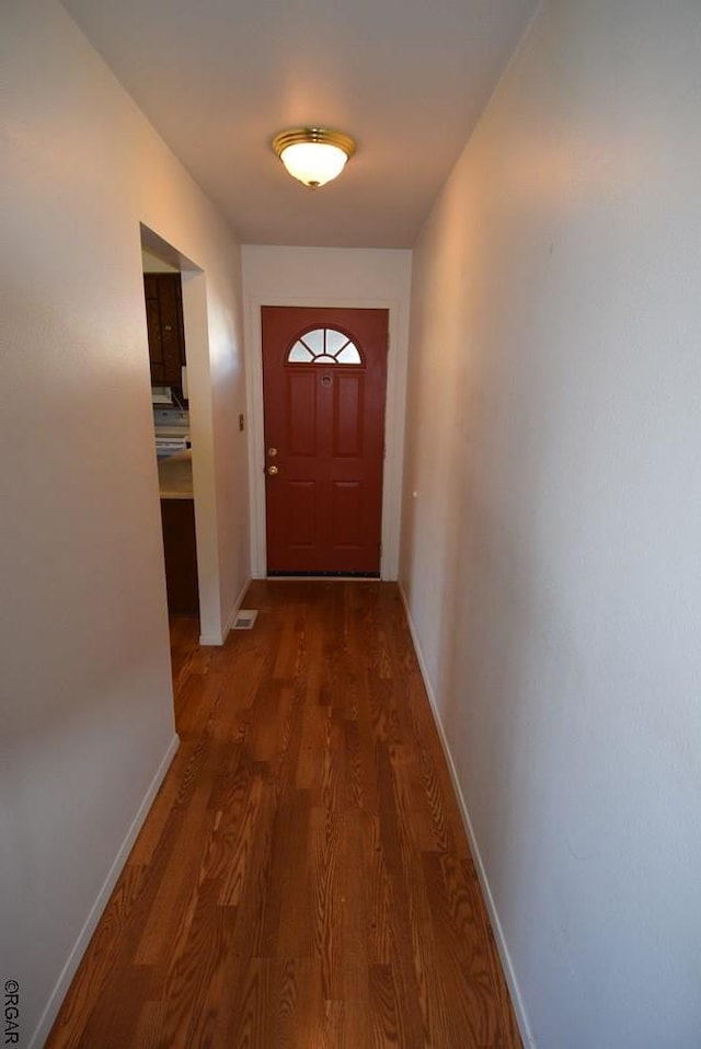 doorway to outside featuring dark wood-type flooring