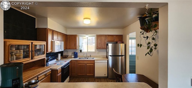 kitchen featuring sink, white appliances, and dark hardwood / wood-style floors