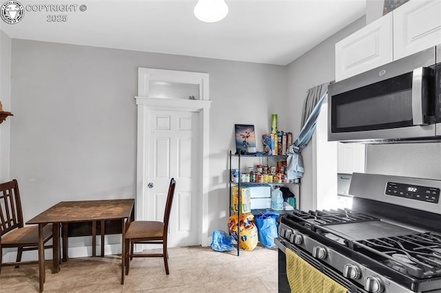 kitchen featuring white cabinets and appliances with stainless steel finishes