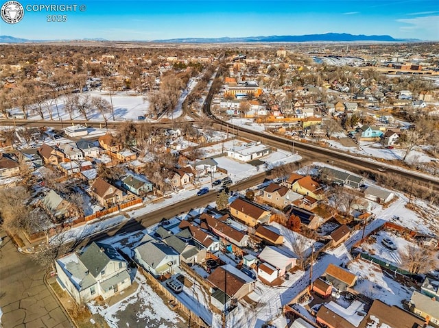 snowy aerial view featuring a mountain view