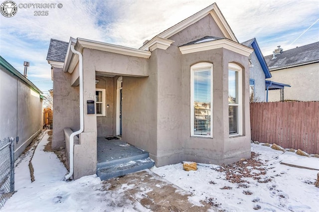 view of snow covered property entrance