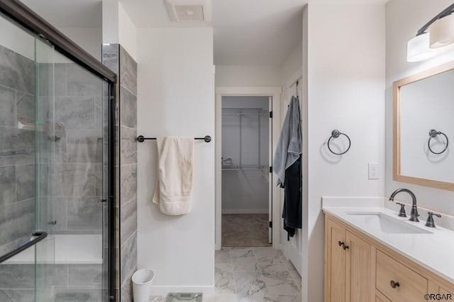 bathroom with vanity and a shower with shower door