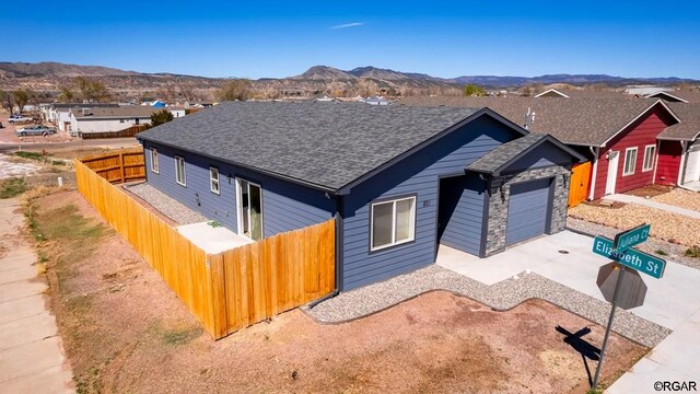 view of front of home featuring a mountain view and a garage