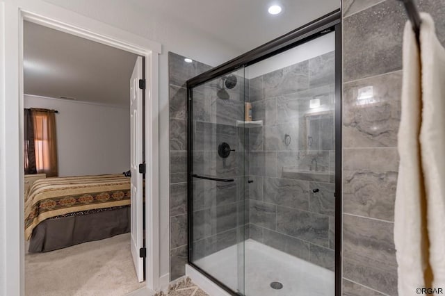 bathroom featuring a shower with shower door