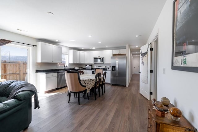 kitchen featuring dark wood-type flooring, stainless steel appliances, and white cabinets