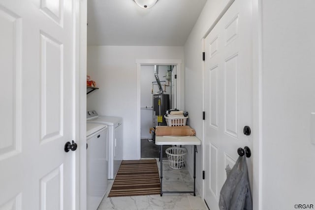 clothes washing area with gas water heater and washer and dryer