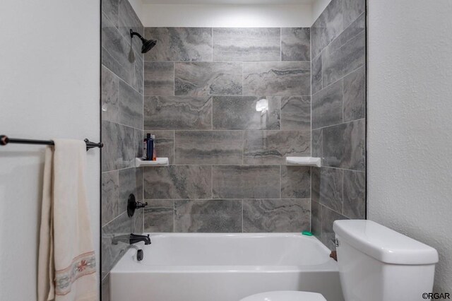 bathroom featuring toilet and tiled shower / bath combo