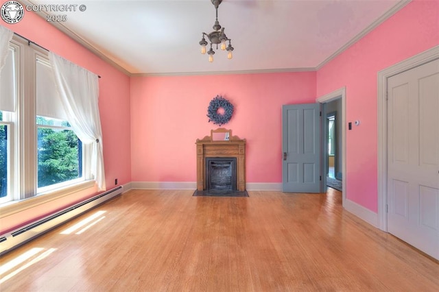 417 Greenwood Ave, Canon City, CO 81212 - unfurnished living room with a baseboard heating unit, light wood finished floors, ornamental molding, a chandelier, and a fireplace with flush hearth