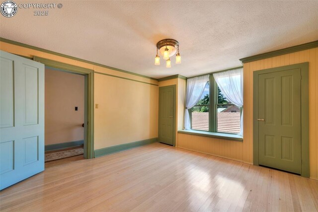 417 Greenwood Ave, Canon City, CO 81212 - unfurnished room featuring crown molding, light wood-style flooring, and a textured ceiling
