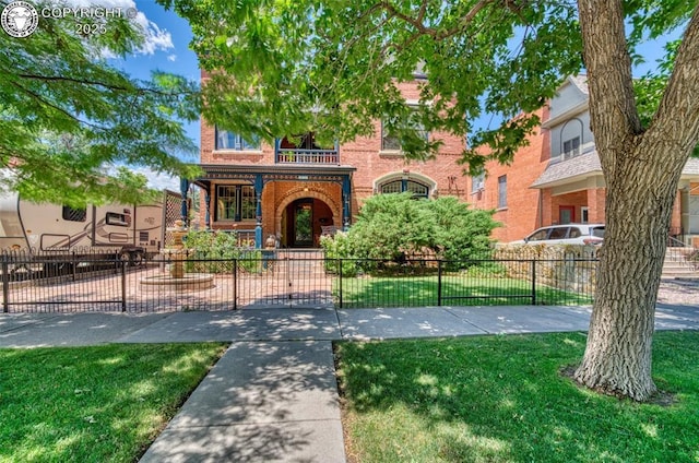 417 Greenwood Ave, Canon City, CO 81212 - view of front of house featuring brick siding, a balcony, and a fenced front yard