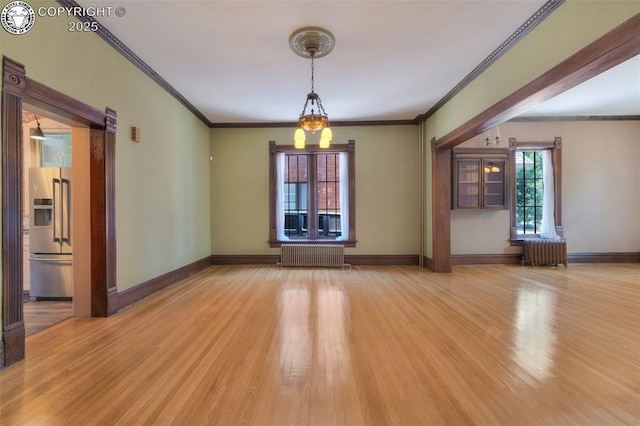 417 Greenwood Ave, Canon City, CO 81212 - unfurnished room featuring radiator heating unit, ornamental molding, and wood finished floors