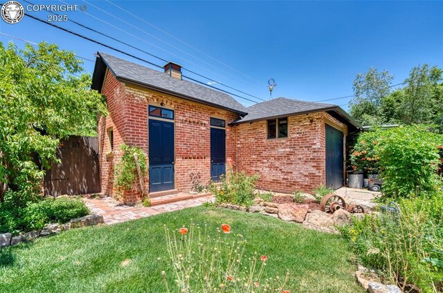 417 Greenwood Ave, Canon City, CO 81212 - view of front of home featuring brick siding, a shingled roof, and a chimney
