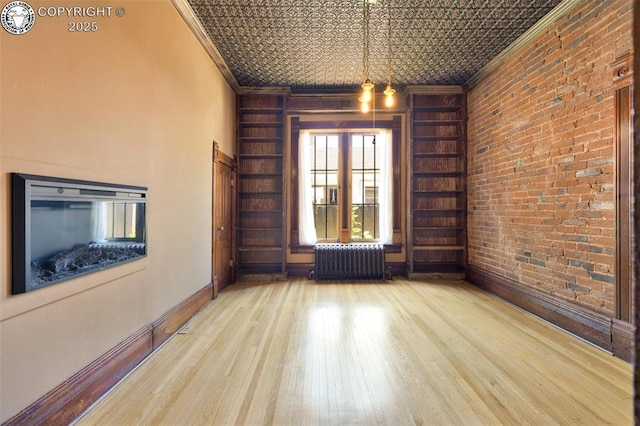 417 Greenwood Ave, Canon City, CO 81212 - unfurnished room with radiator, crown molding, wood finished floors, and an ornate ceiling