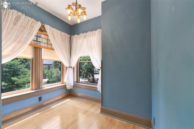 417 Greenwood Ave, Canon City, CO 81212 - unfurnished room featuring a chandelier and wood finished floors
