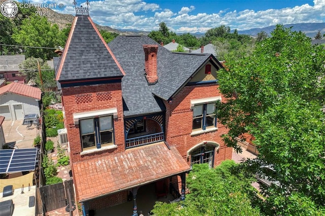 417 Greenwood Ave, Canon City, CO 81212 - view of front of house featuring roof with shingles, brick siding, and a mountain view