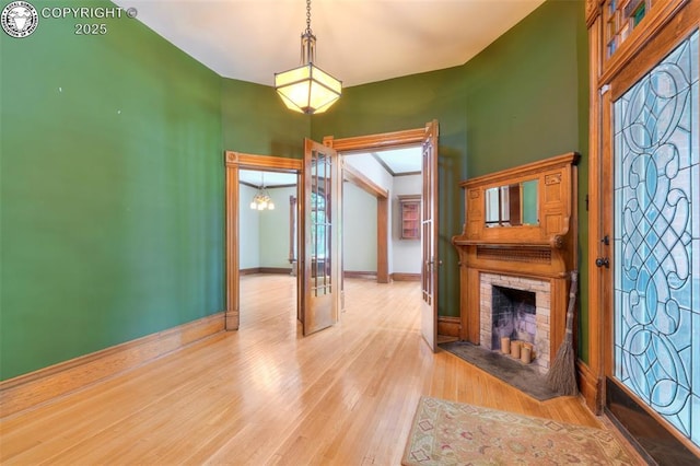 417 Greenwood Ave, Canon City, CO 81212 - unfurnished living room featuring a fireplace, wood finished floors, and a chandelier