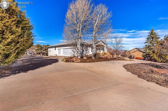 ranch-style house featuring driveway and an attached garage