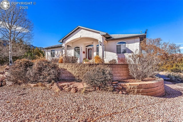 view of front of home featuring fence and stucco siding