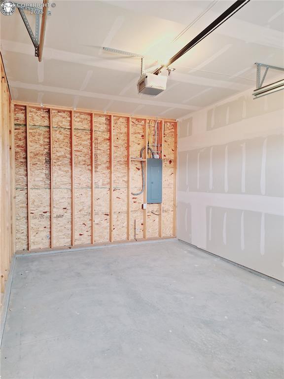 138 Jerry Dr, Westcliffe, CO 81252 - garage with electric panel and a garage door opener