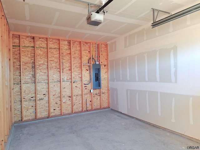 garage with a garage door opener and electric panel