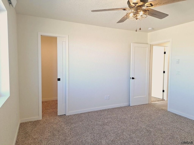 empty room featuring light carpet and ceiling fan