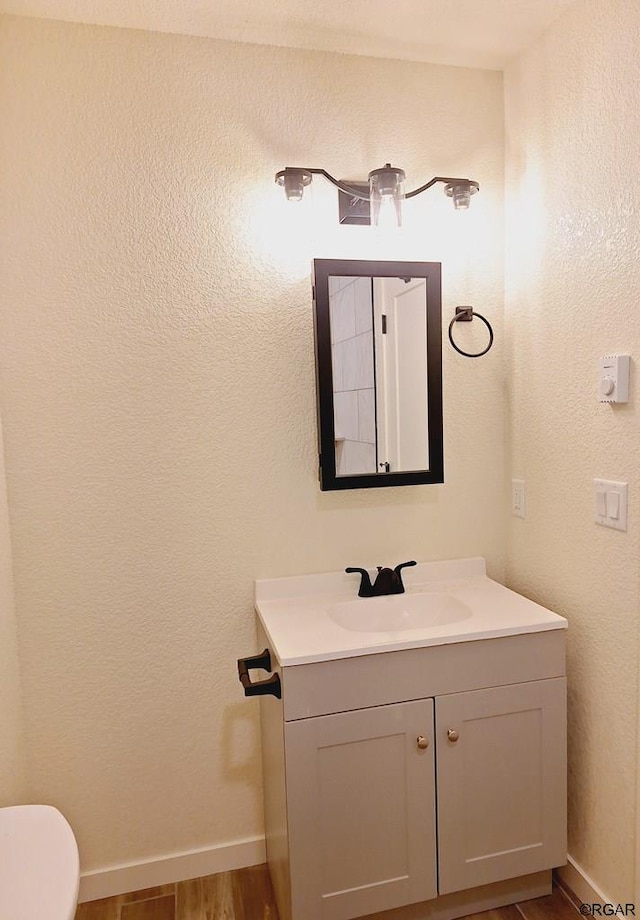 bathroom featuring vanity and hardwood / wood-style floors