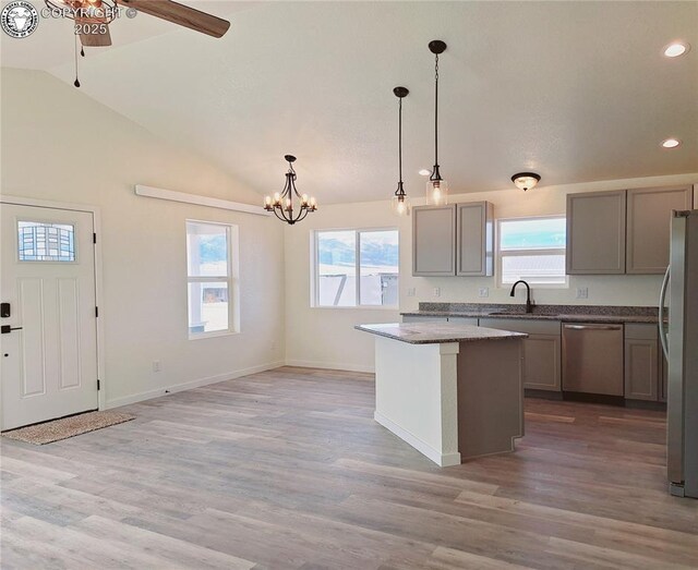138 Jerry Dr, Westcliffe, CO 81252 - kitchen with lofted ceiling, light wood-type flooring, stainless steel appliances, ceiling fan with notable chandelier, and a sink