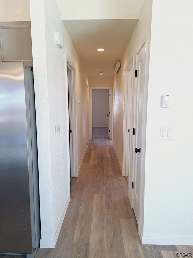 corridor with light hardwood / wood-style flooring