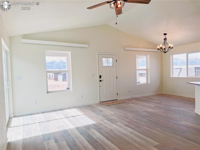 138 Jerry Dr, Westcliffe, CO 81252 - foyer entrance with ceiling fan with notable chandelier, vaulted ceiling, light wood-style flooring, and baseboards