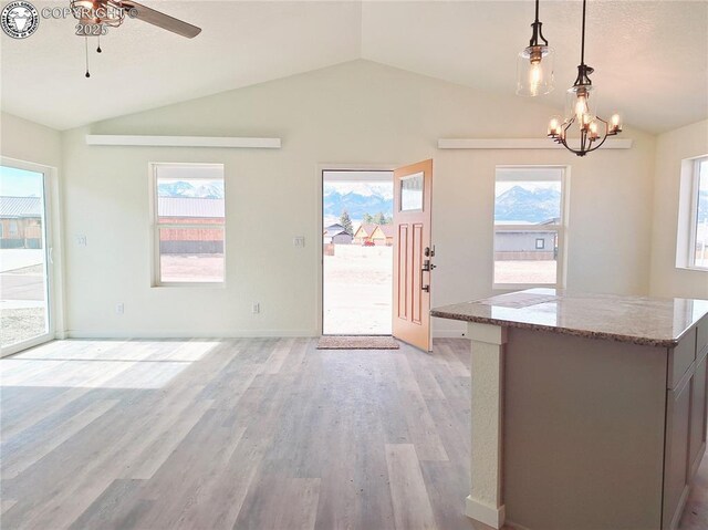 138 Jerry Dr, Westcliffe, CO 81252 - interior space with lofted ceiling, ceiling fan with notable chandelier, light wood-style floors, pendant lighting, and light stone countertops