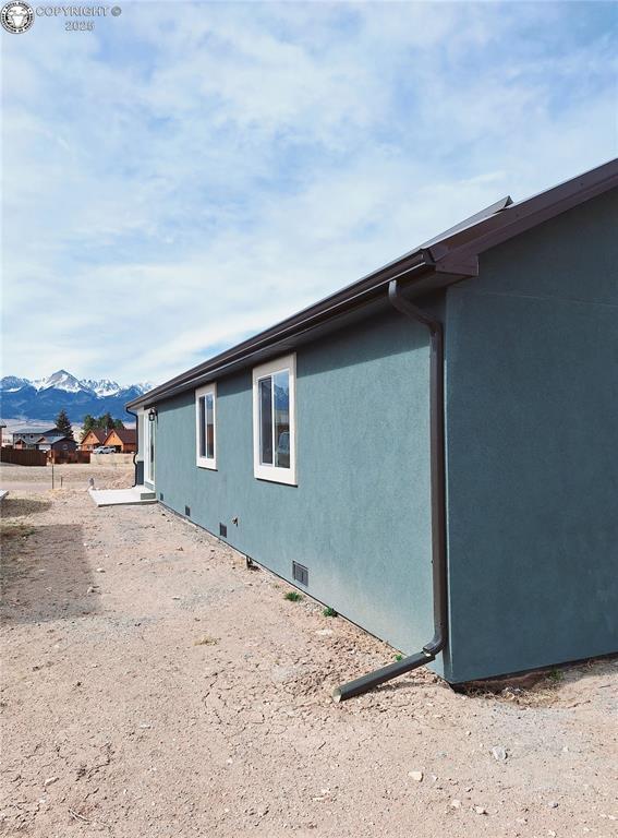 138 Jerry Dr, Westcliffe, CO 81252 - view of side of home featuring crawl space, stucco siding, and a mountain view