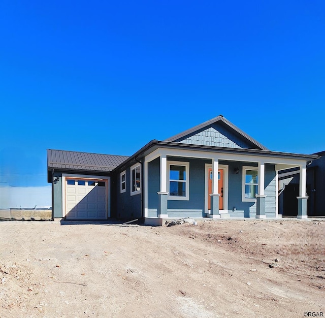 view of front of house featuring a porch and a garage