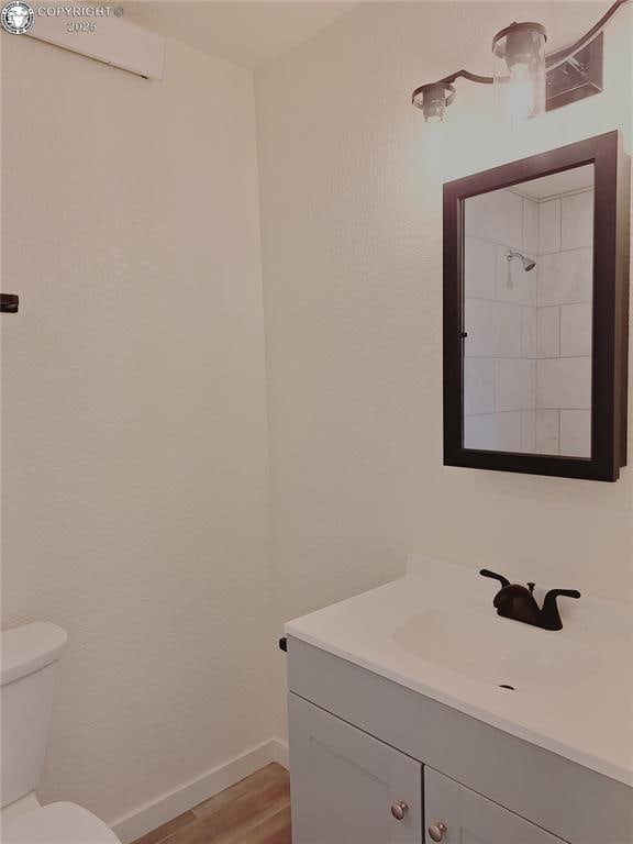 138 Jerry Dr, Westcliffe, CO 81252 - bathroom featuring baseboards, toilet, vanity, and wood finished floors