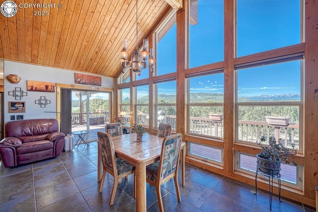 2680 Wild Bill Blvd, Westcliffe, CO 81252 - dining space featuring a mountain view, wood ceiling, stone tile flooring, a chandelier, and high vaulted ceiling