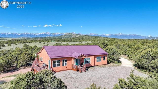 2680 Wild Bill Blvd, Westcliffe, CO 81252 - view of front of property with stucco siding, a mountain view, a metal roof, and gravel driveway