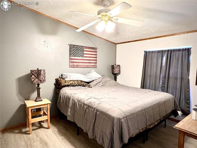 925 C St, Penrose, CO 81240 - bedroom with ornamental molding, wood finished floors, vaulted ceiling, a textured ceiling, and a ceiling fan