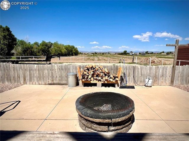 925 C St, Penrose, CO 81240 - fenced backyard featuring an outdoor fire pit, a patio, and a view of countryside