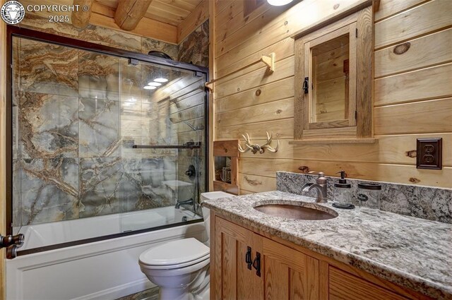 540 County Road 356, Westcliffe, CO 81252 - full bathroom with vanity, toilet, wood walls, bath / shower combo with glass door, and wooden ceiling