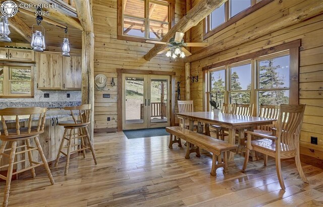 540 County Road 356, Westcliffe, CO 81252 - dining area with wood walls, plenty of natural light, french doors, light wood-style floors, and ceiling fan