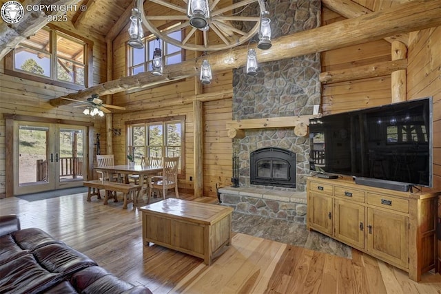540 County Road 356, Westcliffe, CO 81252 - living room with high vaulted ceiling, plenty of natural light, wooden walls, ceiling fan, and light wood-type flooring